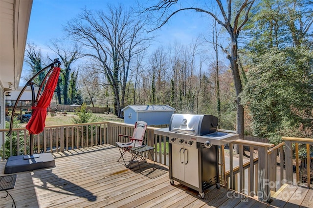 deck with a grill, an outdoor structure, and a shed