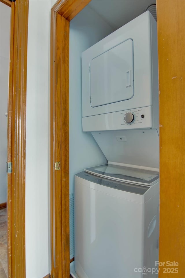 laundry room featuring stacked washing maching and dryer and laundry area