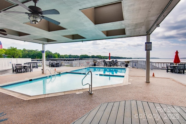 pool featuring a ceiling fan, a patio, and fence