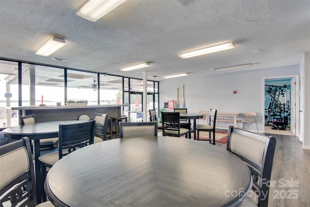 dining area featuring a textured ceiling and wood finished floors