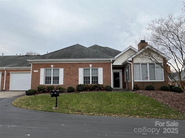 ranch-style house with a front yard, a chimney, a garage, aphalt driveway, and brick siding