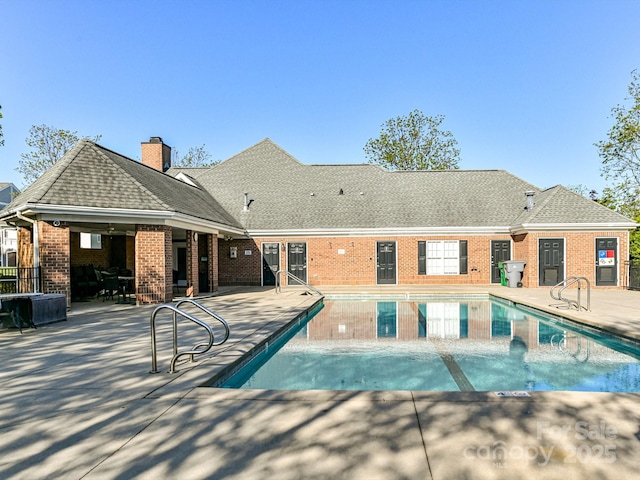 outdoor pool featuring a patio