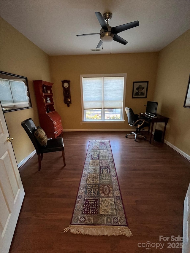 living area featuring a ceiling fan, wood finished floors, visible vents, and baseboards