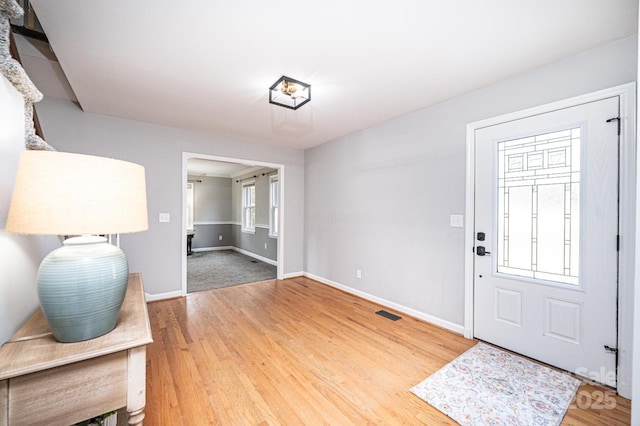 entrance foyer featuring wood finished floors and baseboards