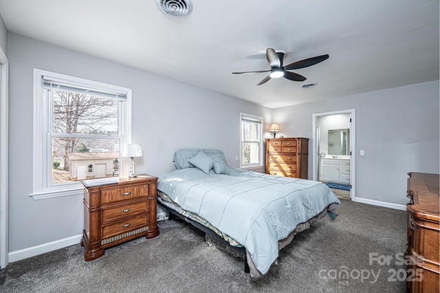 carpeted bedroom with visible vents, ensuite bath, and baseboards