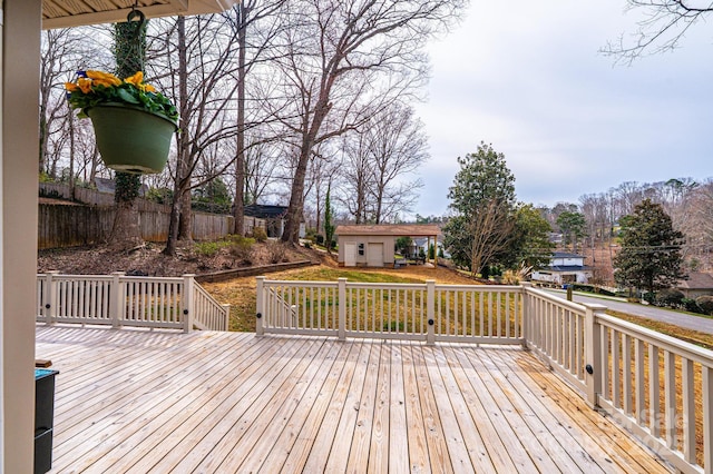 wooden terrace with a yard and an outdoor structure