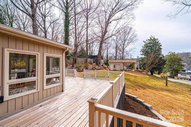 wooden deck with an outbuilding and a yard