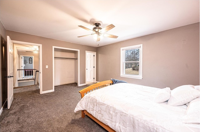 carpeted bedroom featuring a closet, baseboards, and a ceiling fan