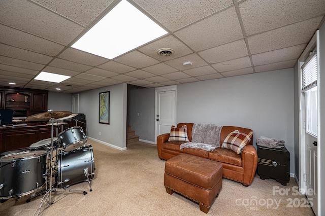 living room featuring visible vents, light carpet, baseboards, a paneled ceiling, and stairs