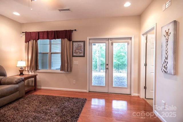 interior space with recessed lighting, wood finished floors, visible vents, and baseboards