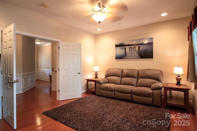 living room with recessed lighting, wainscoting, wood finished floors, a decorative wall, and a ceiling fan