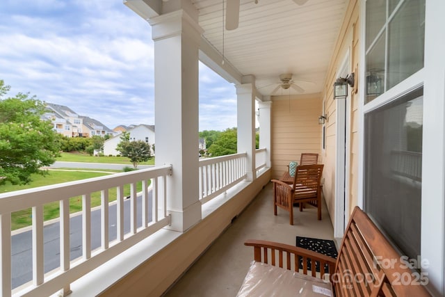 balcony with a residential view and ceiling fan