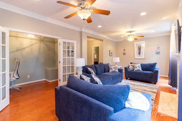 living area with baseboards, ornamental molding, ceiling fan, french doors, and light wood-style floors