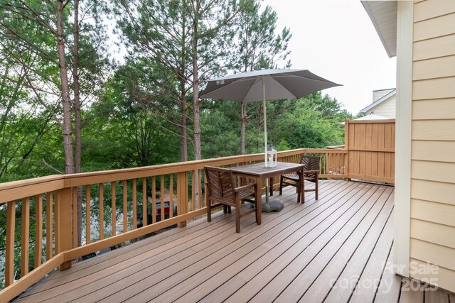 wooden terrace with outdoor dining area