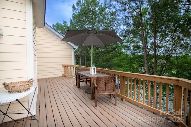 wooden terrace featuring outdoor dining space