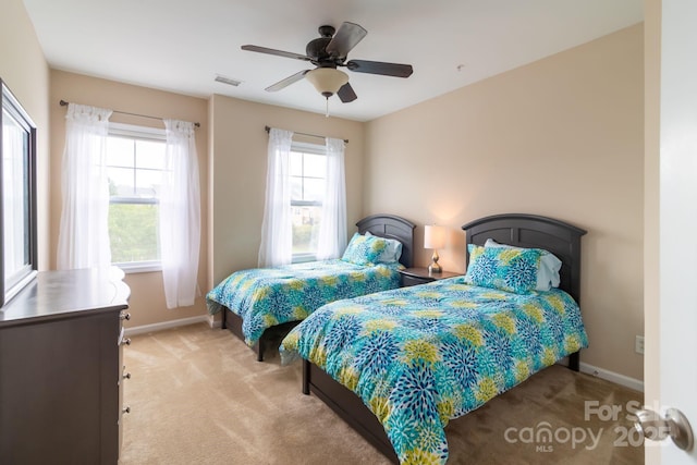 bedroom featuring visible vents, baseboards, ceiling fan, and carpet flooring