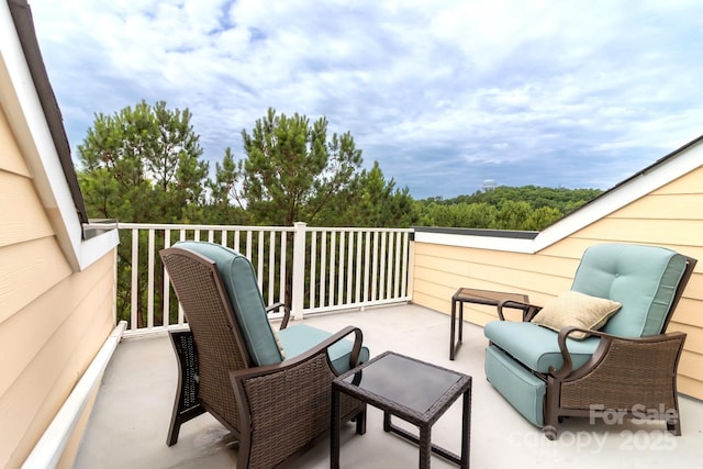 view of patio featuring a balcony