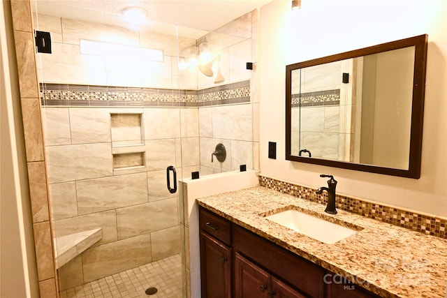 full bathroom featuring vanity and a shower stall