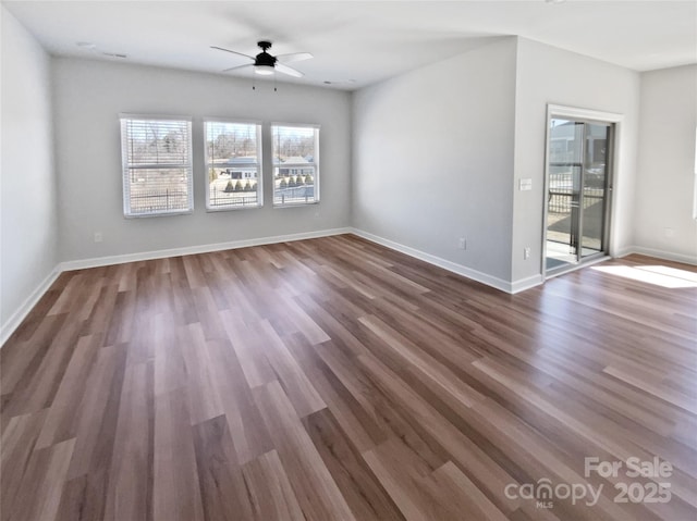 spare room featuring baseboards, a ceiling fan, and wood finished floors