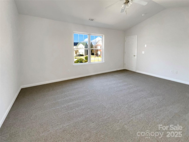 carpeted spare room with visible vents, lofted ceiling, baseboards, and ceiling fan