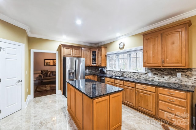 kitchen with dark stone counters, brown cabinets, appliances with stainless steel finishes, marble finish floor, and a sink