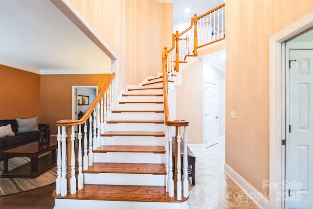 stairs with baseboards, marble finish floor, and crown molding