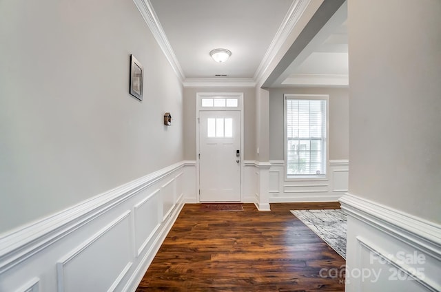 entryway featuring dark wood-type flooring, wainscoting, and ornamental molding