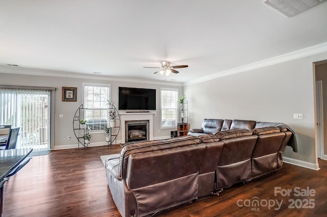 living area with visible vents, baseboards, ceiling fan, dark wood finished floors, and ornamental molding