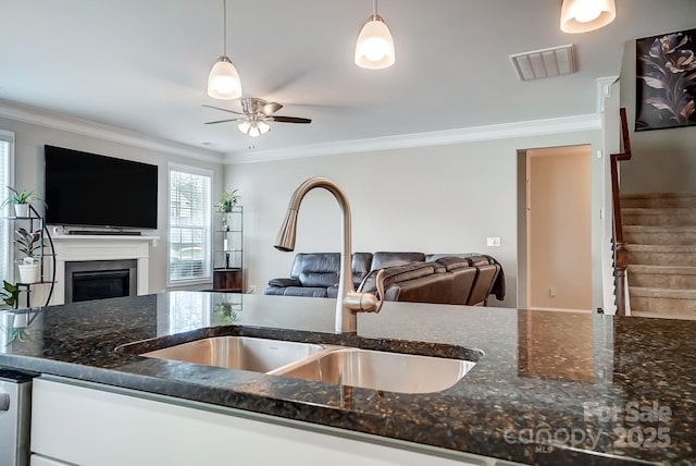 kitchen with visible vents, open floor plan, and a sink