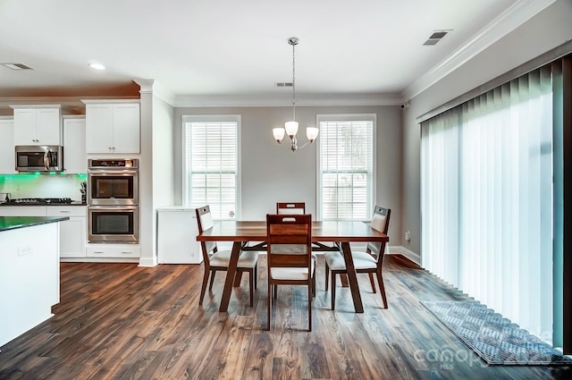 dining space with an inviting chandelier, dark wood-style floors, visible vents, and ornamental molding