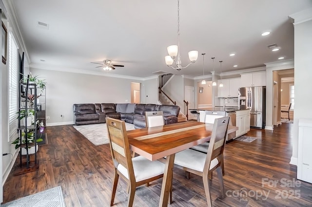 dining room featuring visible vents, stairs, and crown molding