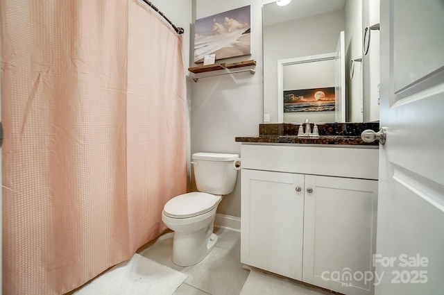 bathroom with tile patterned floors, a shower with shower curtain, toilet, and vanity