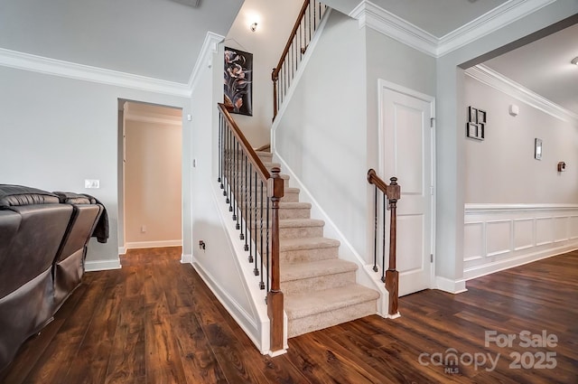 stairway featuring crown molding and wood finished floors