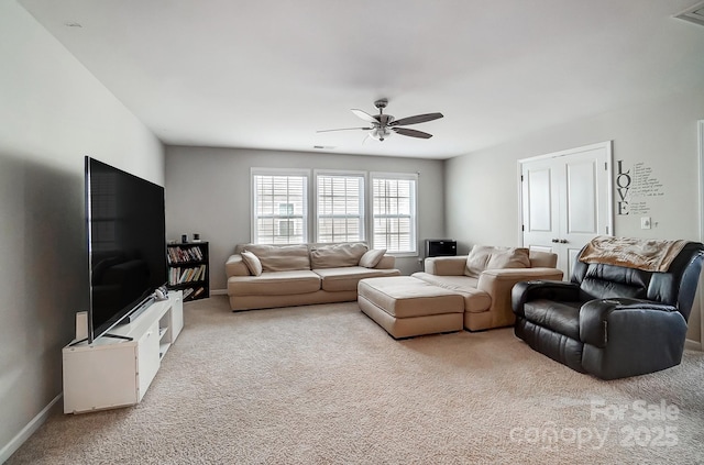 carpeted living room with visible vents, baseboards, and a ceiling fan