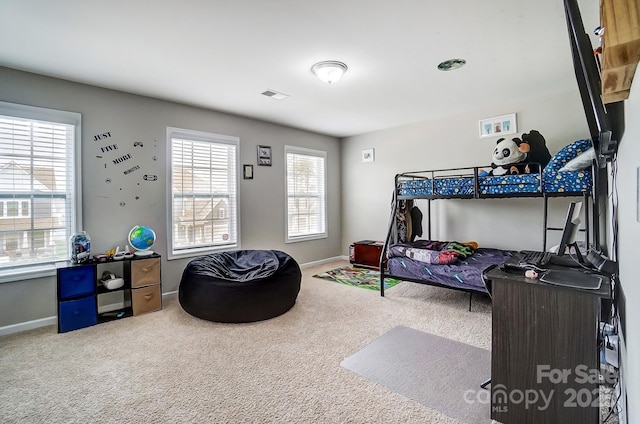 carpeted bedroom with visible vents and baseboards