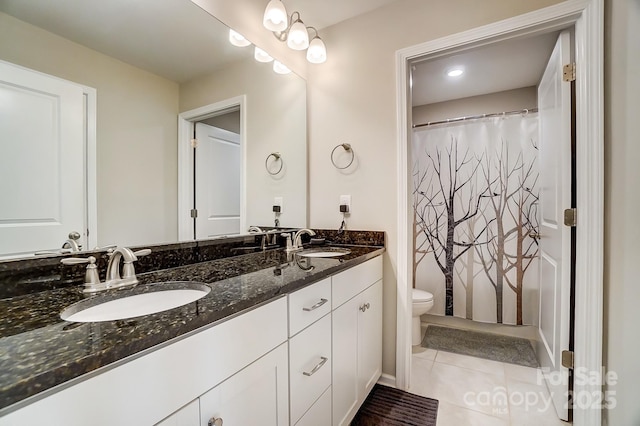 full bath with tile patterned flooring, double vanity, toilet, and a sink