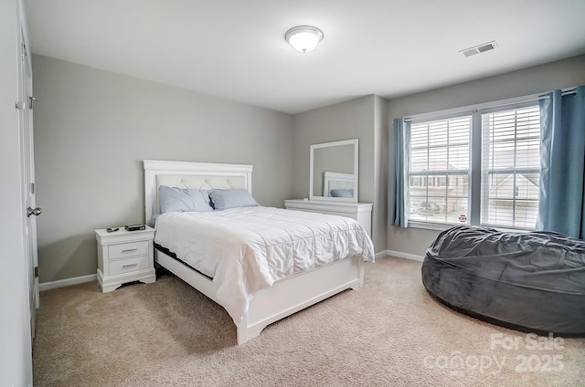 carpeted bedroom with baseboards and visible vents