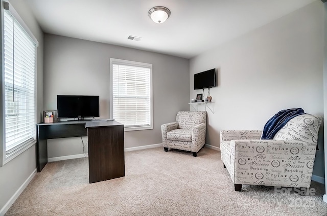 office space featuring visible vents, carpet flooring, and baseboards