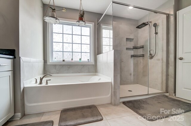 full bath featuring a bath, tile patterned floors, and a stall shower