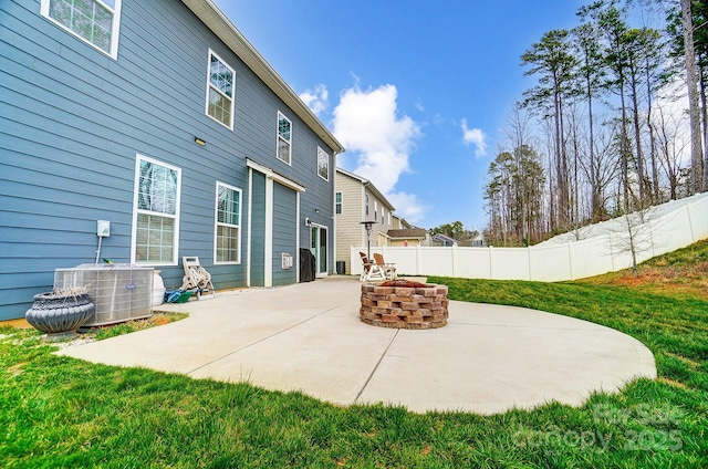 rear view of house with central AC unit, a patio, and fence