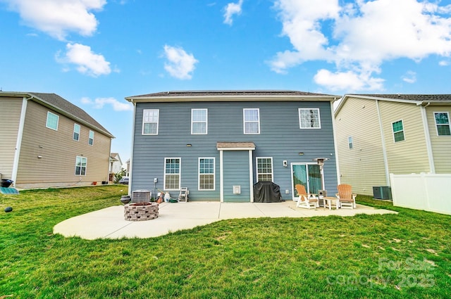 rear view of property featuring a patio, fence, an outdoor fire pit, a yard, and central air condition unit