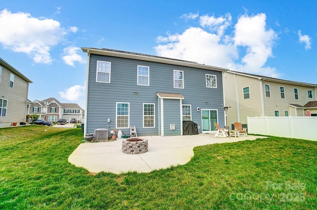 back of property featuring a patio, fence, a lawn, and a fire pit