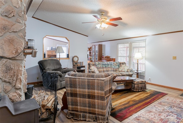 living room featuring wood finished floors, a textured ceiling, ornamental molding, and a ceiling fan