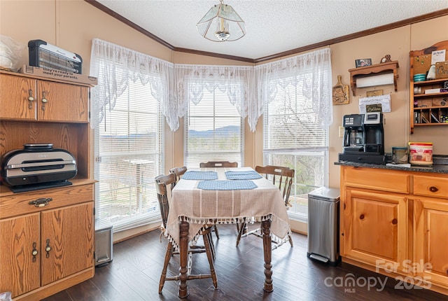 dining area with a textured ceiling, dark wood-style flooring, and crown molding