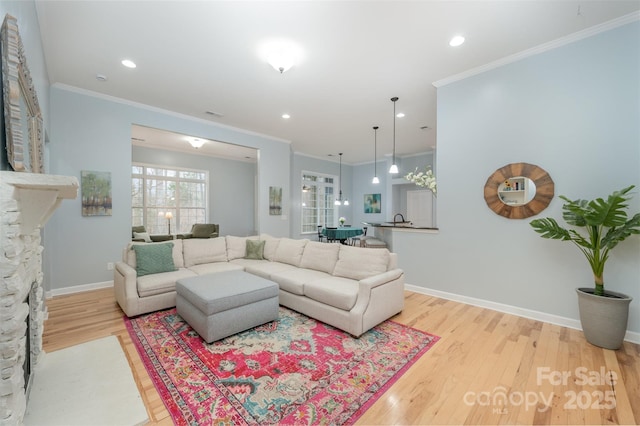 living area with recessed lighting, wood finished floors, baseboards, and ornamental molding