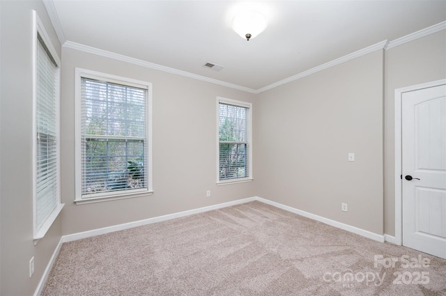 carpeted empty room with baseboards, visible vents, and ornamental molding