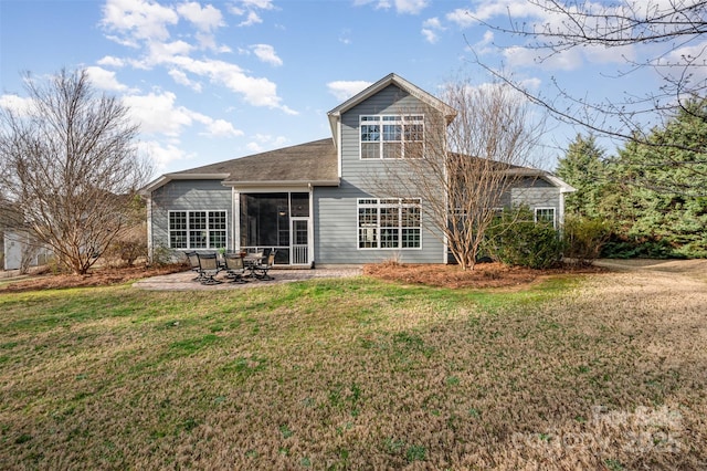 back of property featuring a patio, a yard, and a sunroom