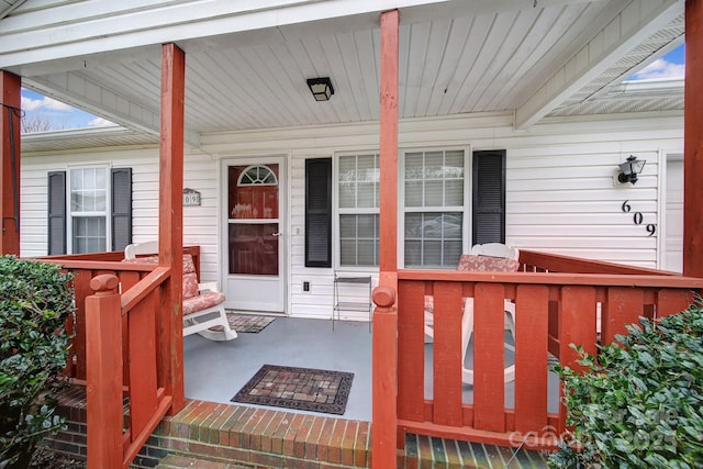 view of exterior entry featuring a porch