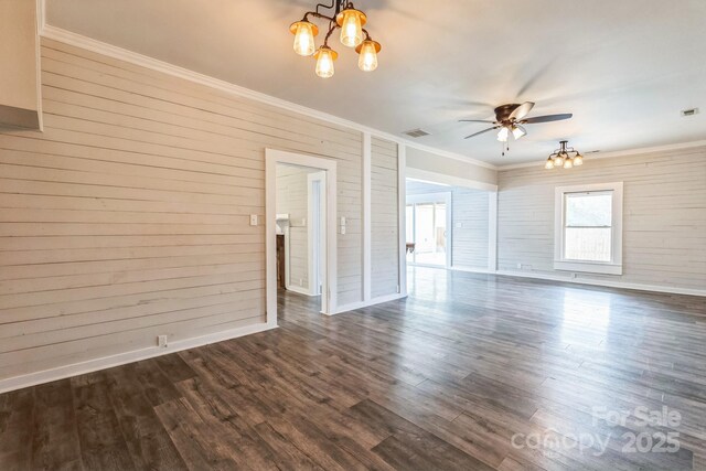 3607 Austin Rd, Monroe, NC 28112 - empty room with dark wood-style floors, ceiling fan with notable chandelier, visible vents, and ornamental molding