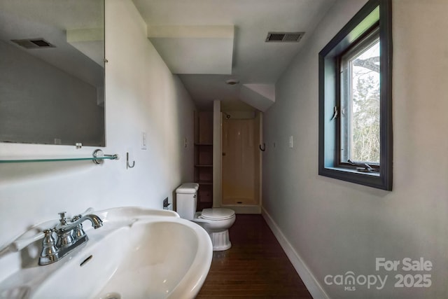 3607 Austin Rd, Monroe, NC 28112 - bathroom featuring toilet, a shower, visible vents, and a sink
